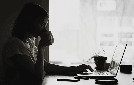 woman researching online on laptop