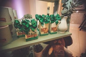 Assorted freebie items on display with giveaway signs on a table.
