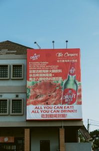 Seafood restaurant billboard with promotional offers, highlighting pricing and turnaround time