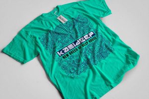 Teal T-shirt featuring a complex music-themed doodle and the text "NEW BREED OF DEEP HOUSE."