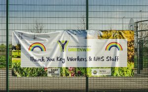 Community thank-you banner on a fence showing how custom banners create targeted messaging