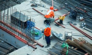 Construction workers in bright safety gear, showcasing ways of strengthening brand recognition.
