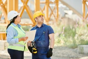 Two supervisors in hard hats at a site, highlighting a way of strengthening team identity.