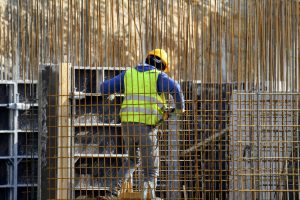 Worker in a high-visibility vest on a job site supporting safety and visibility.