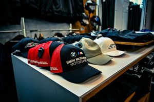 BMW caps displayed on a retail shelf, prioritizing readability over size.